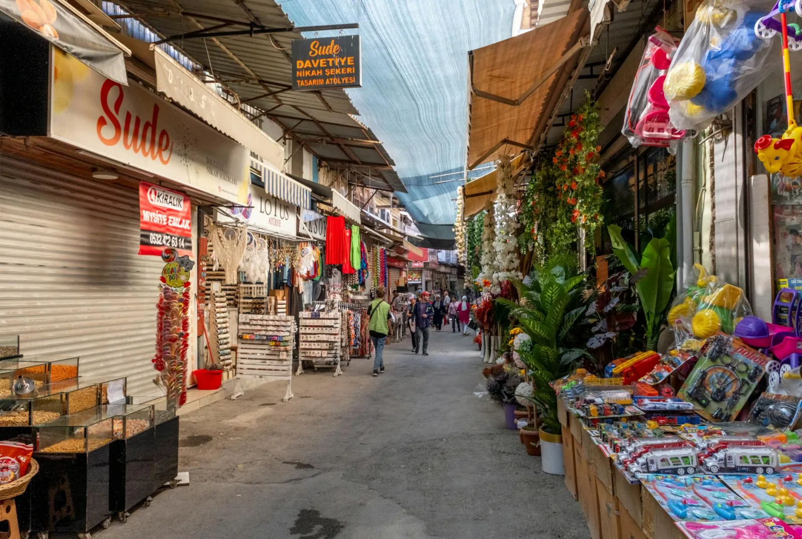 Explore a vibrant market street in İzmir, Türkiye, filled with colorful shops and lively atmosphere.