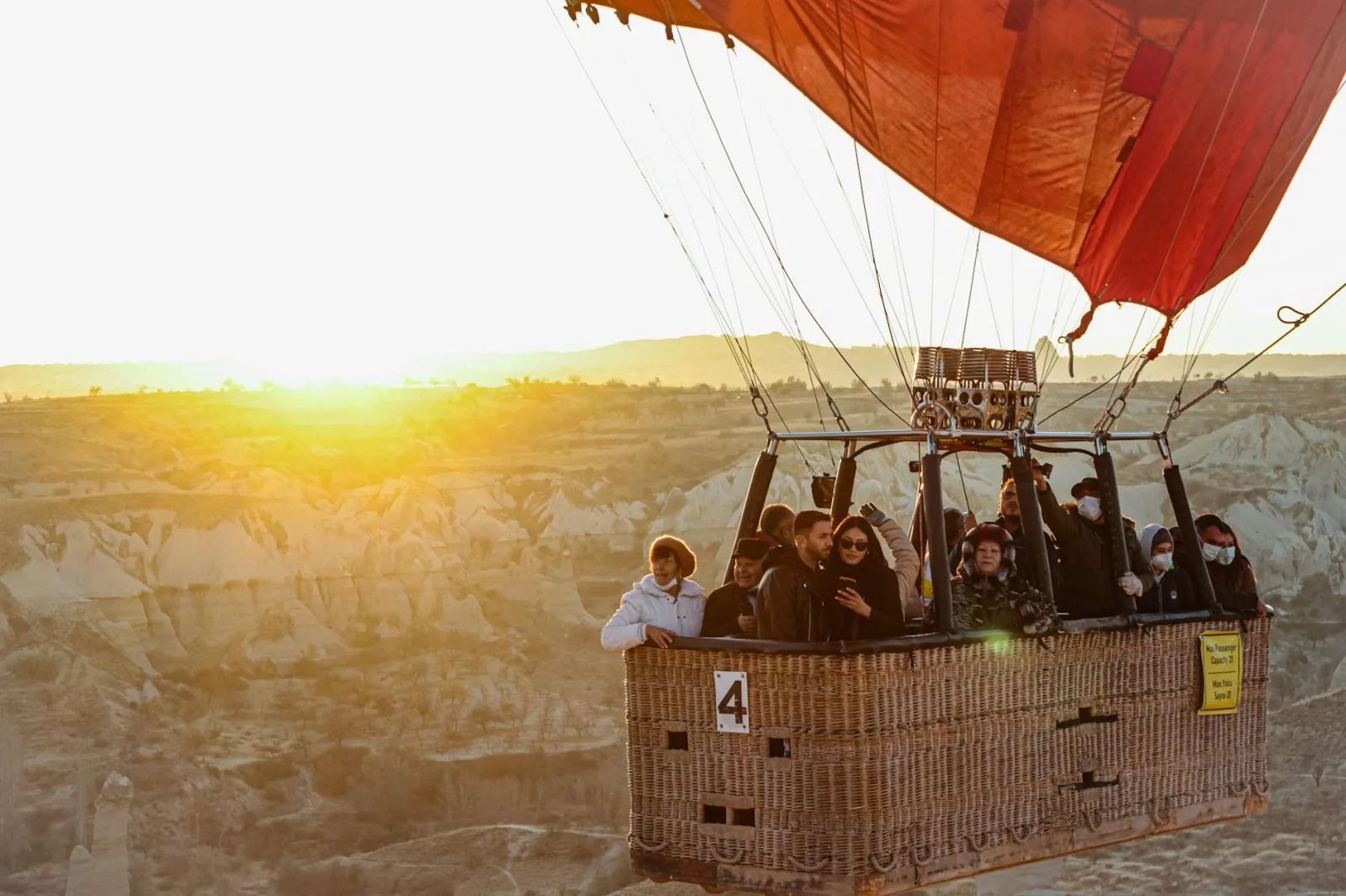Experience a breathtaking hot air balloon ride at sunrise over the stunning landscapes of Cappadocia, Türkiye.