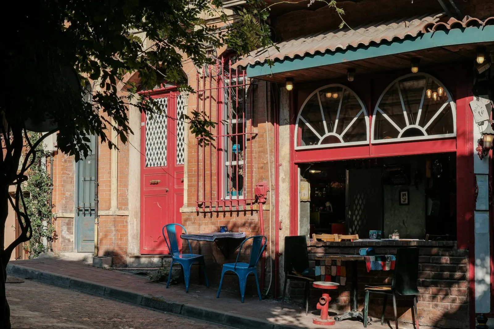 Explore a quaint café in Istanbul's colorful Balat district, capturing the vibrant street life.