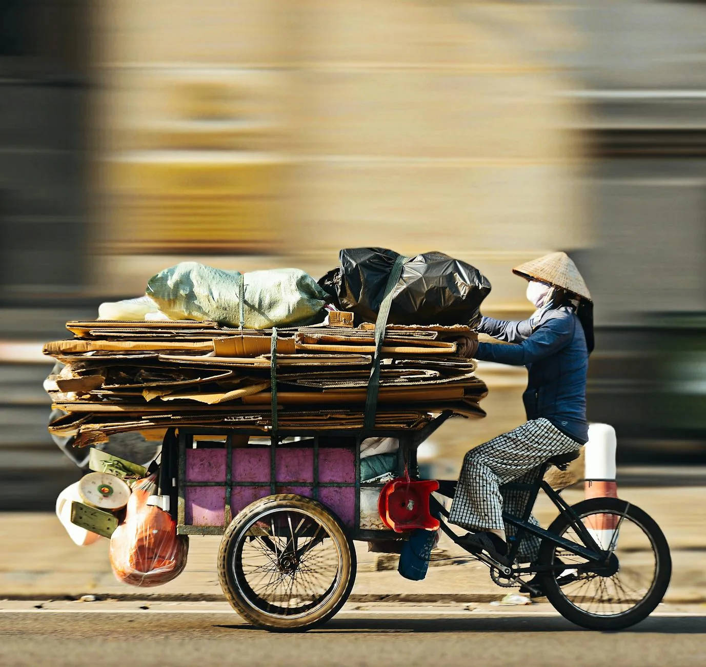 Bicyclist collecting recyclables in Ho Chi Minh City, embodying sustainable living and urban recycling.