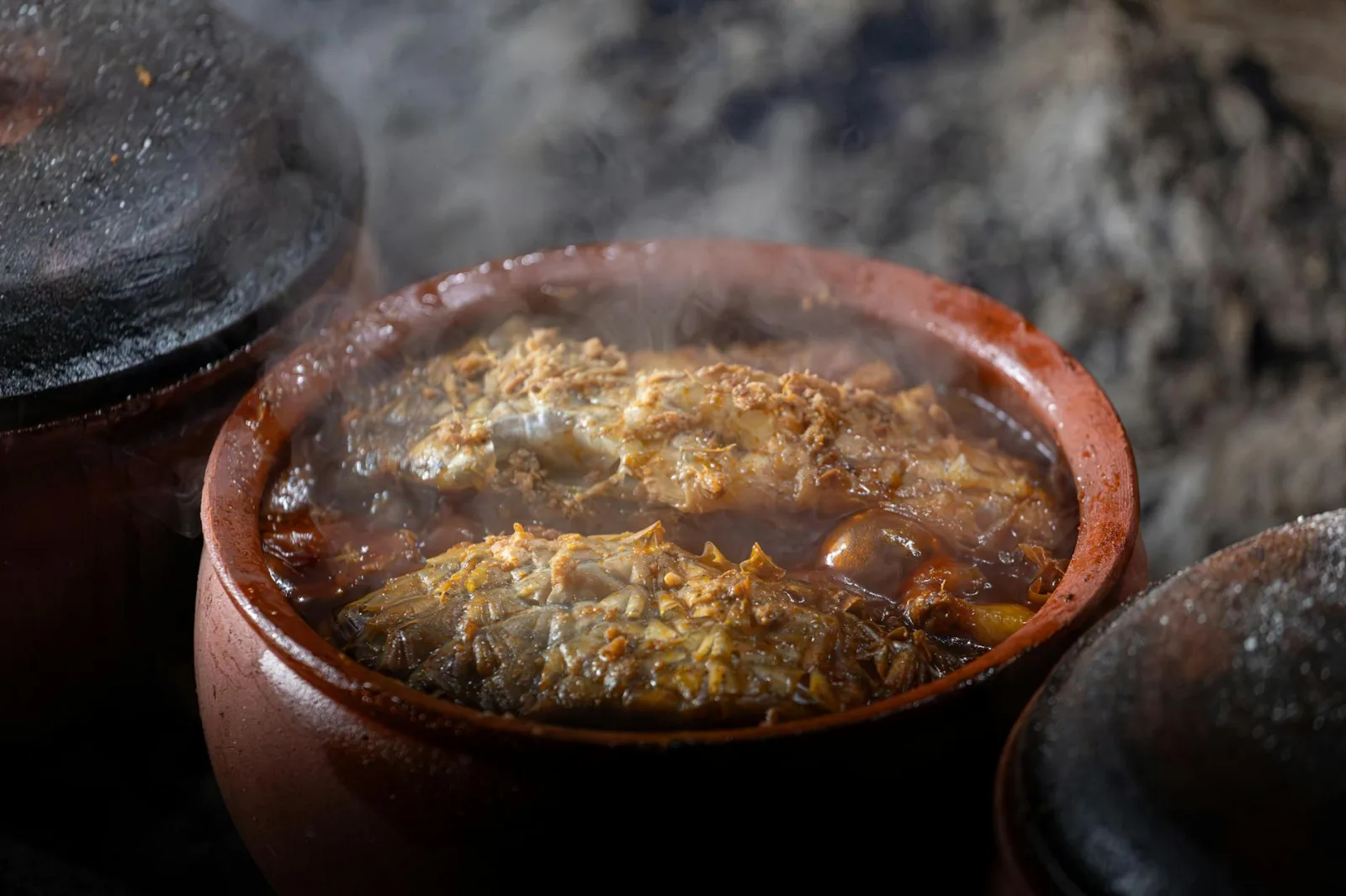 Steaming fish stew in a clay pot, a Vietnamese culinary tradition in Nam Định.