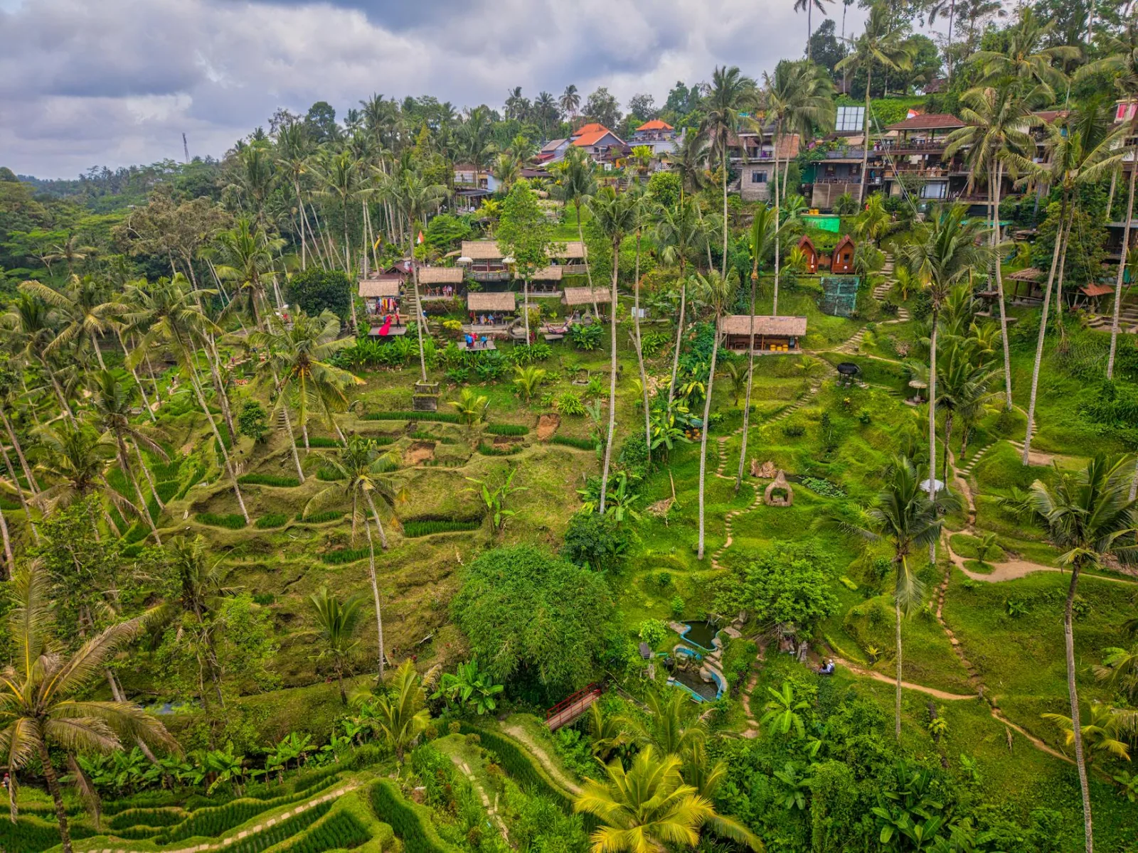 Stunning aerial view of Tegallalang Rice Terraces in Ubud, Bali, showcasing lush greenery and traditional huts.