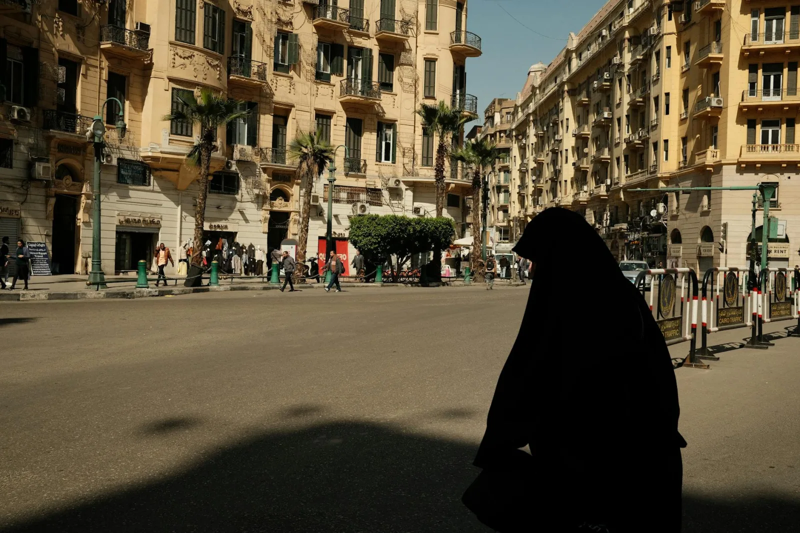 A bustling street view in Cairo, Egypt featuring pedestrians and classic architecture.