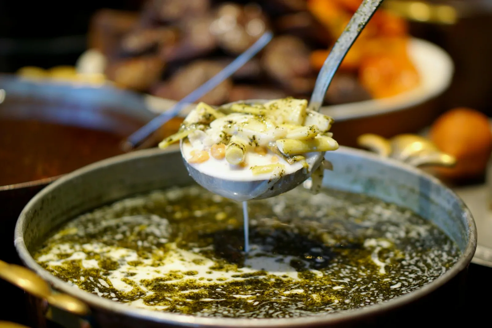 Close-up of traditional Turkish pasta soup being served with rich herbal broth in Gaziantep.