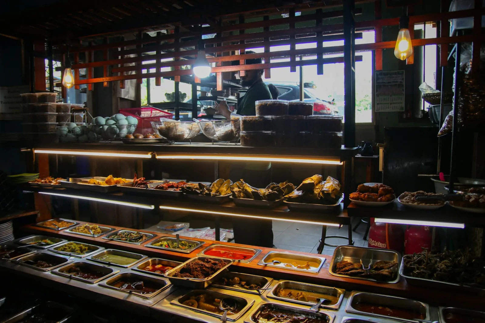 Explore the vibrant variety of Indonesian cuisine in a bustling West Java market buffet.