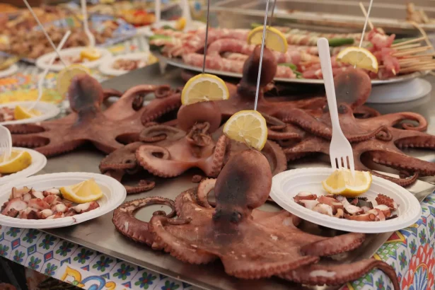 Octopus and lemon dish on vibrant market table in Palermo, Sicily.