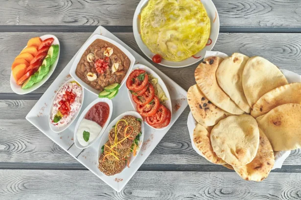 A vibrant spread of Middle Eastern dishes featuring hummus, falafel, and fresh vegetables.