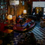 Cozy cafe in Mar del Plata with live guitar music performance, rich ambiance.