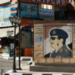 Intriguing street art depicting an Egyptian officer amid bustling shops.