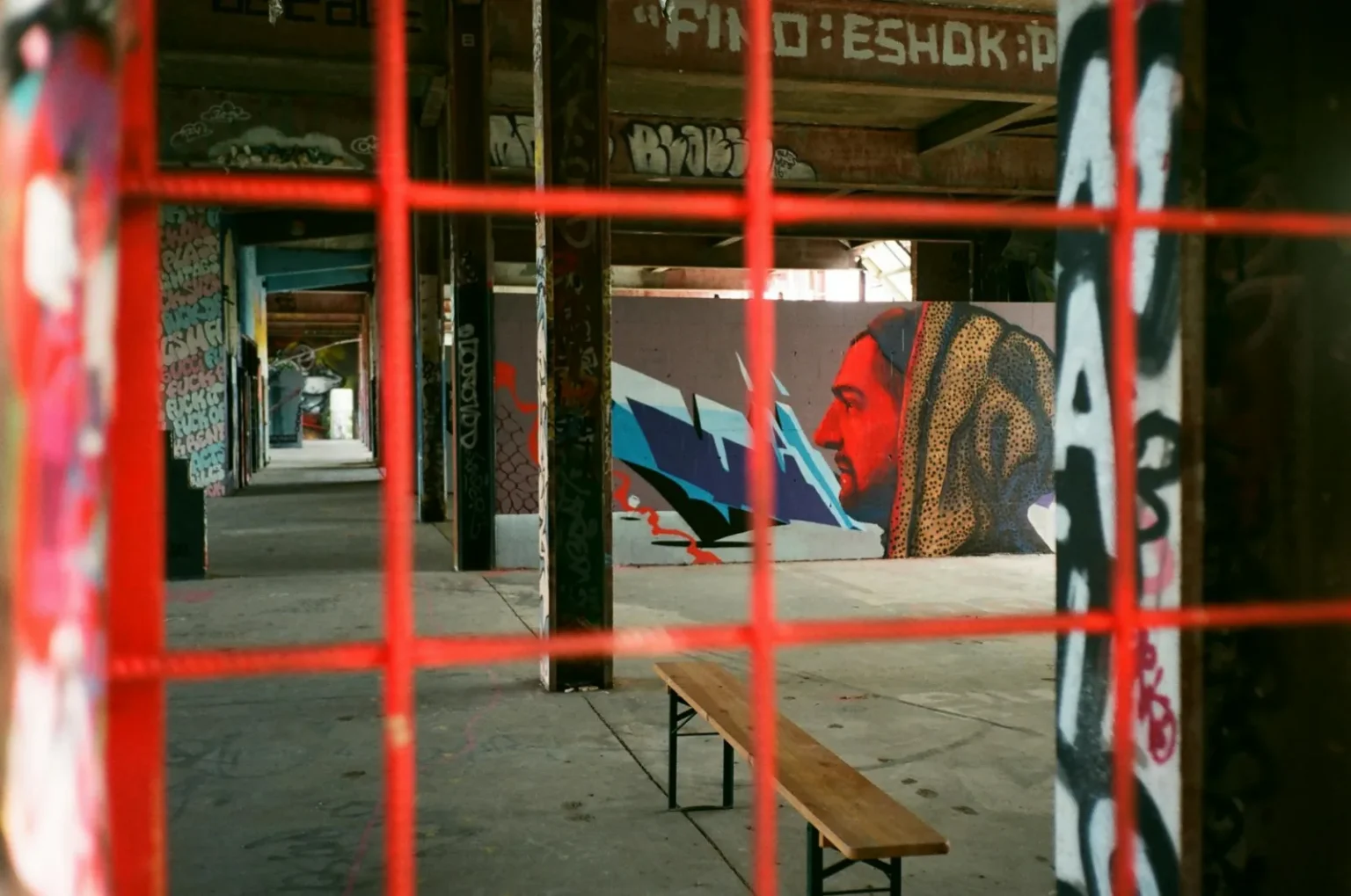 Colorful graffiti art in an abandoned warehouse featuring vibrant street murals and urban decay.