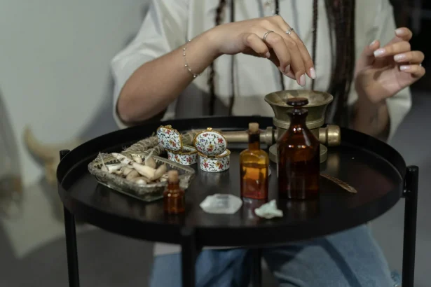 A hand engaging in a spiritual ritual with herbs and bottles on a mystical table.