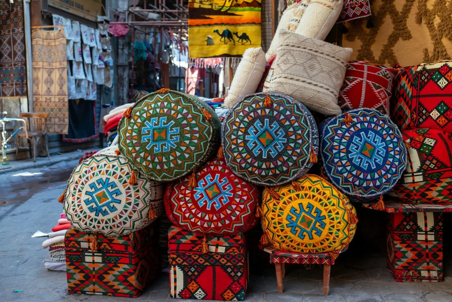 Vibrant handmade textiles and crafts at a Cairo market street.