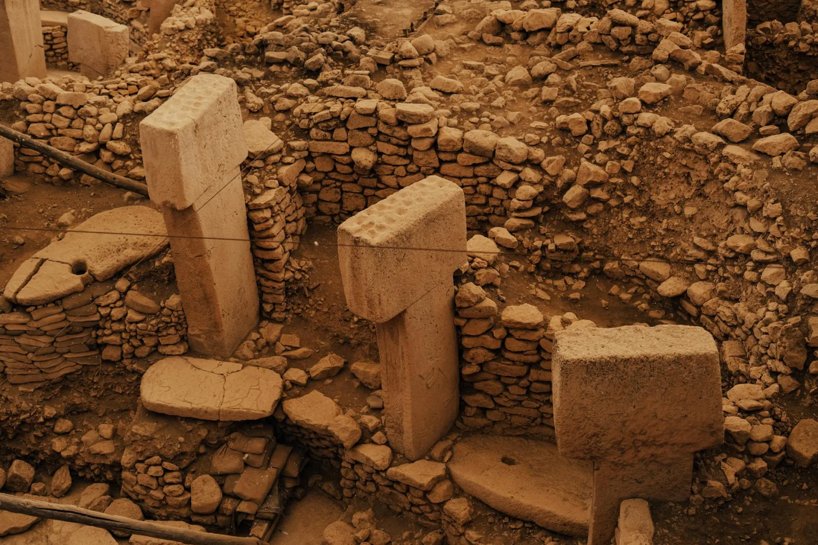Aerial view of Göbeklitepe archaeological site in Şanlıurfa, Türkiye, showcasing ancient stone structures.