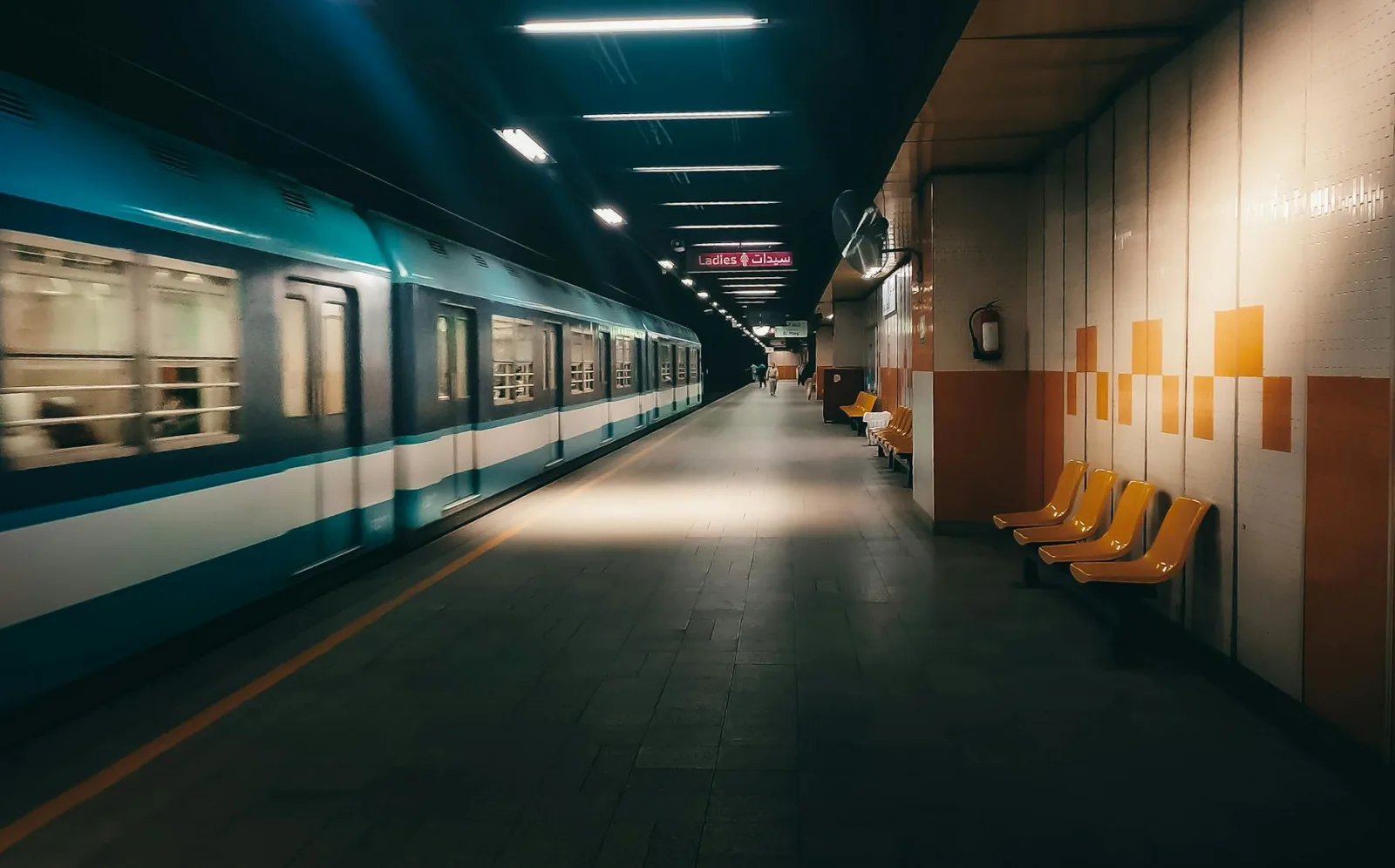 A serene view of an empty metro station platform in Cairo, Egypt at night.