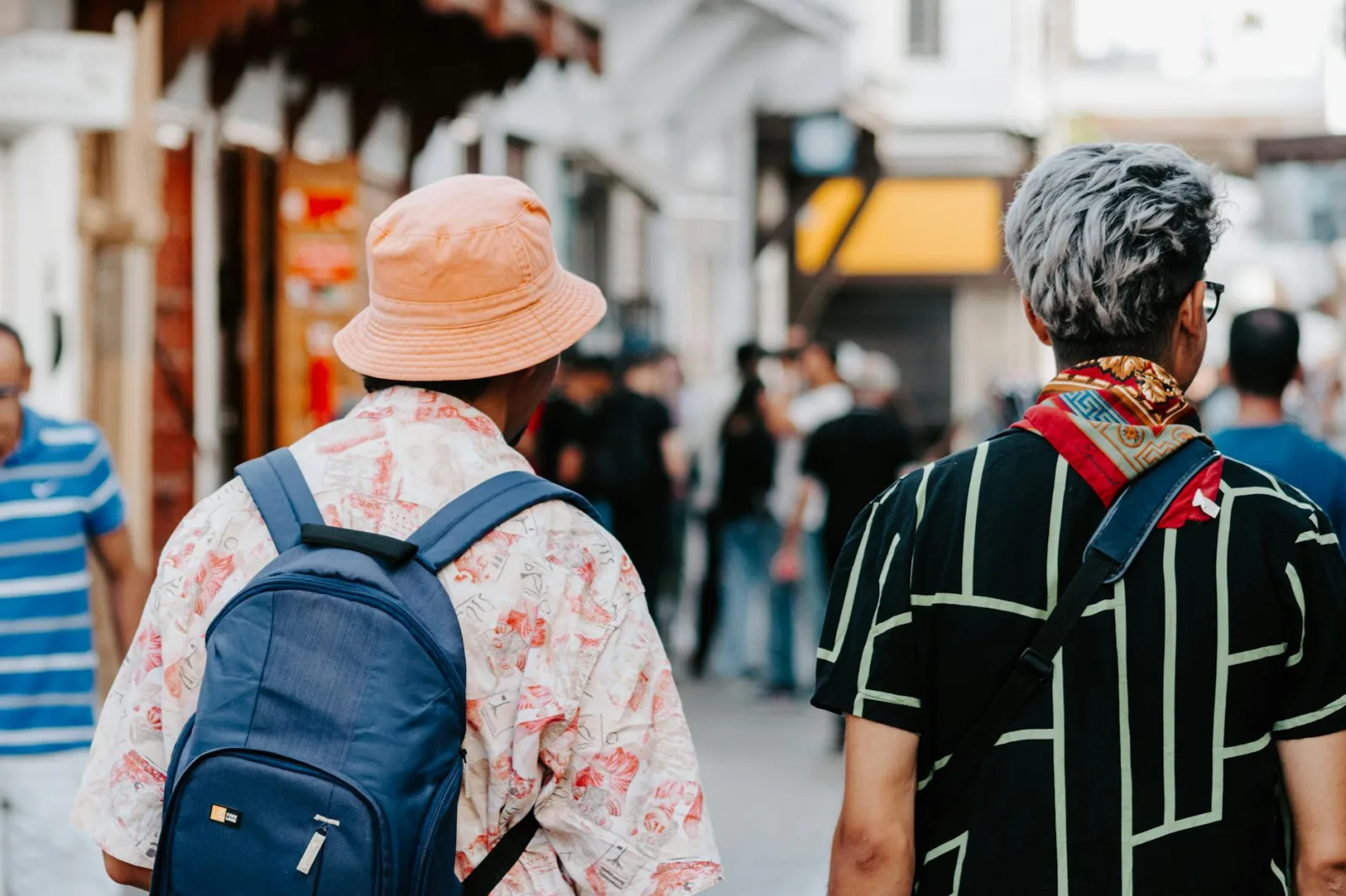 Stylish travelers walking through Rabat's bustling streets, capturing Moroccan urban life.