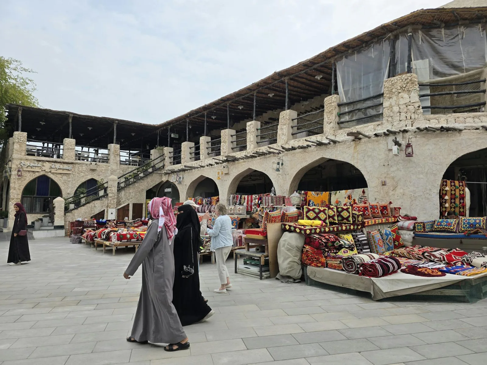 Bustling outdoor souk in the UAE showcasing vibrant textiles and traditional architecture.