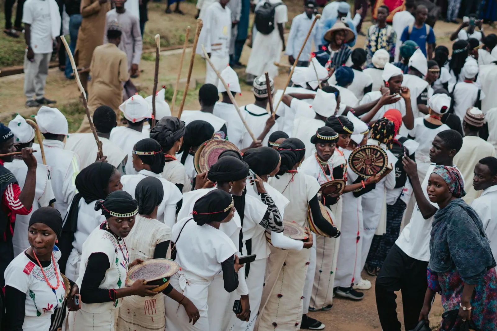A vibrant parade of people in traditional attire during a cultural festival.