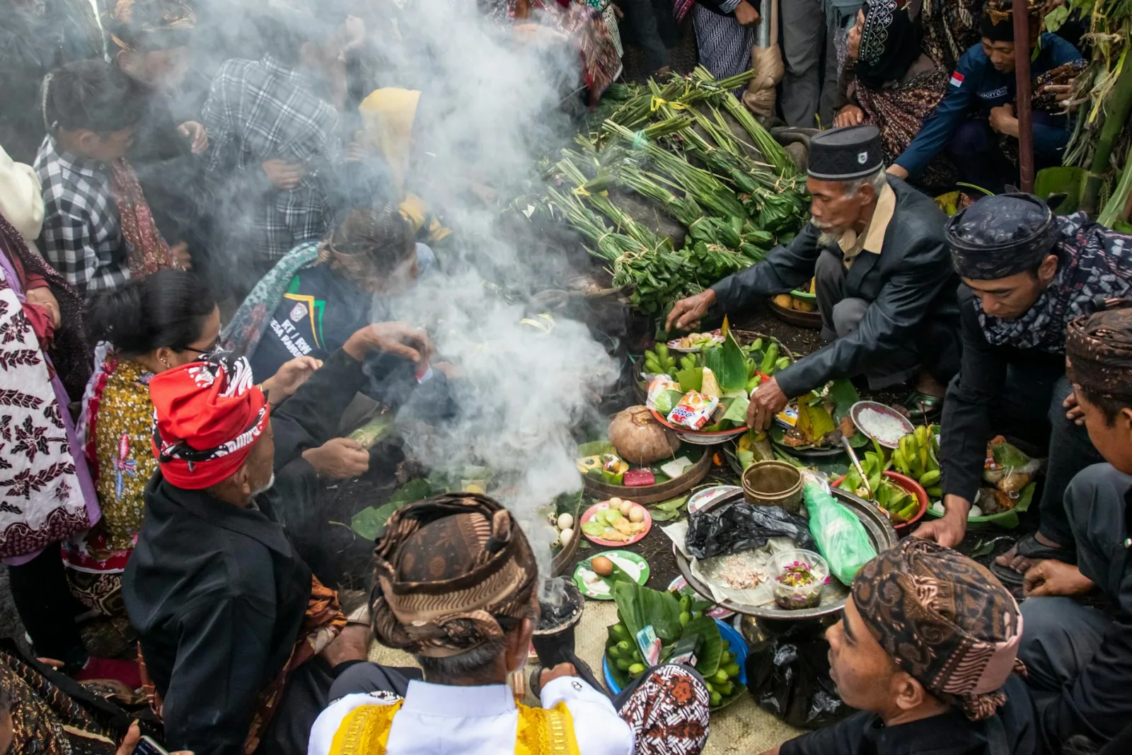 A vibrant cultural gathering with traditional ritual and offerings, rich with diverse attire and greenery.