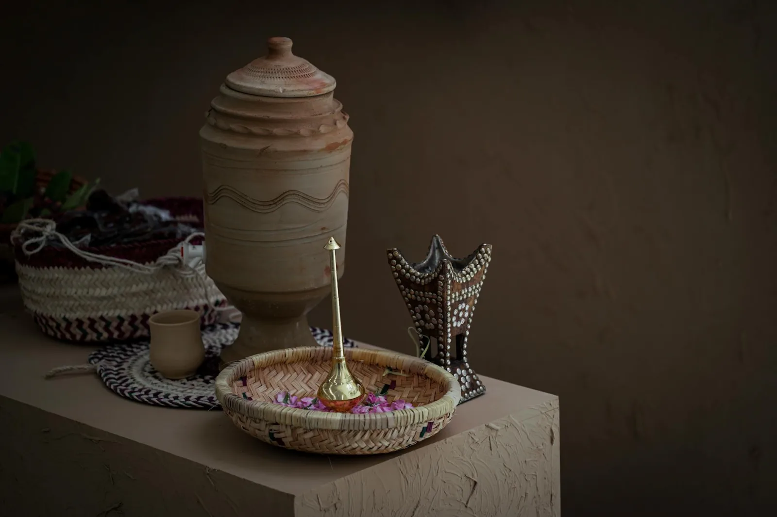 A close-up of traditional Saudi Arabian handcrafted decor including baskets and pottery.