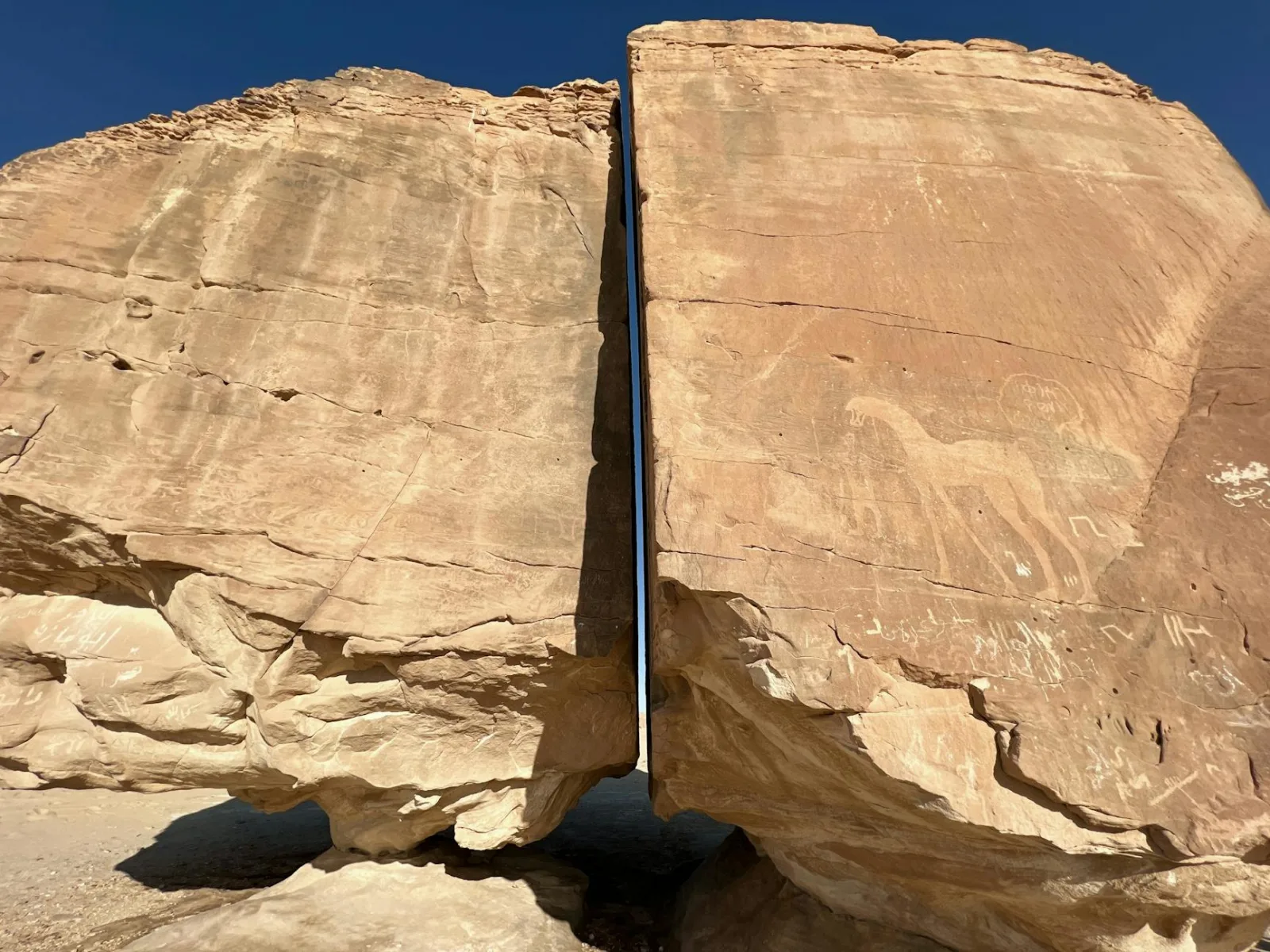 Stunning Al Naslaa rock formation in Saudi Arabia, featuring ancient petroglyphs.