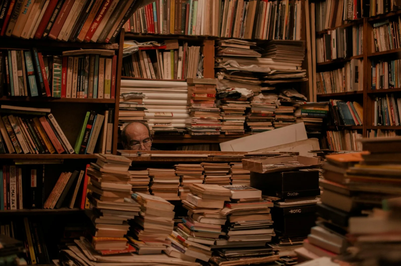 Explore a cluttered bookstore full of stacked books and hidden wisdom.