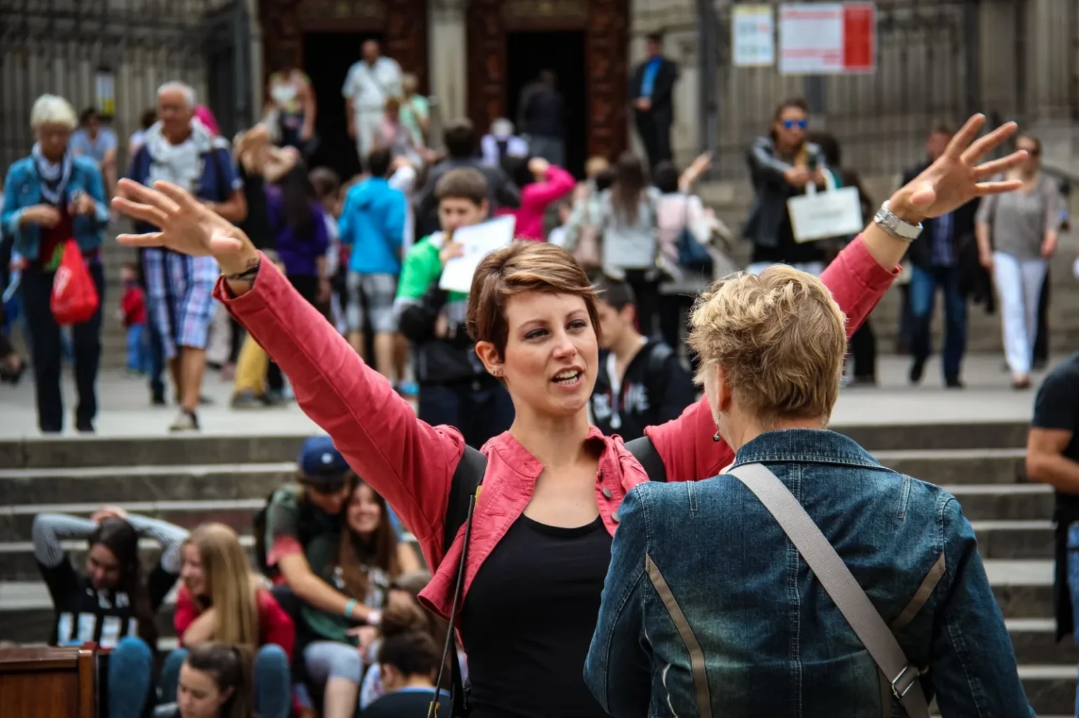 A bustling street scene in Barcelona with people interacting in a vibrant urban setting.