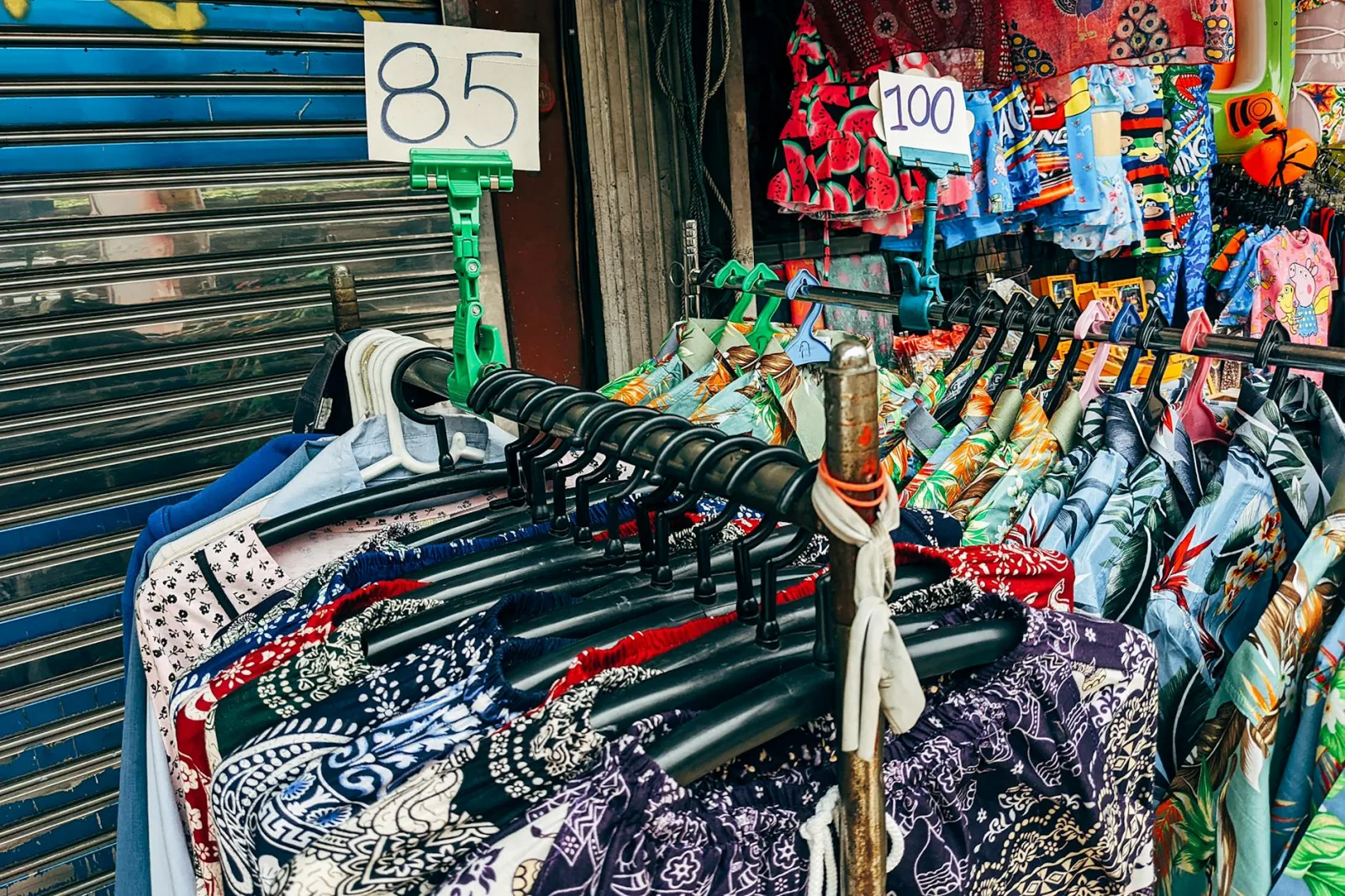 Colorful shirts on display at a street market, showcasing unique patterns and vibrant styles.