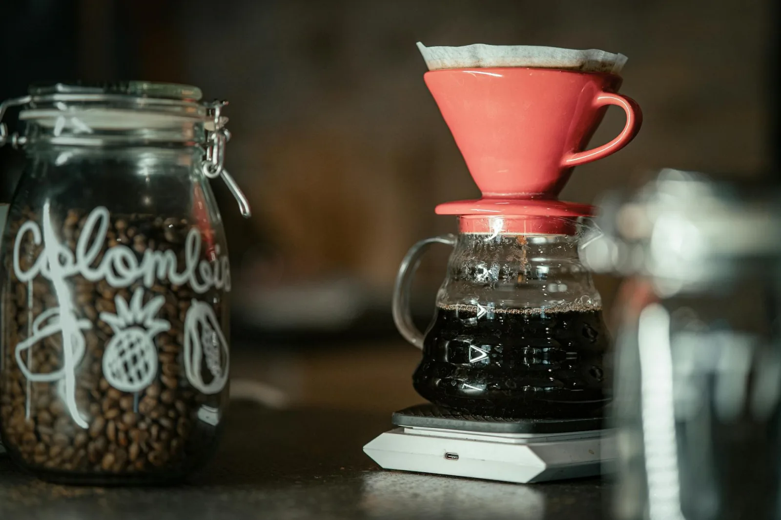 Close-up of a pour-over coffee setup with Colombian beans, highlighting artisanal brewing methods.