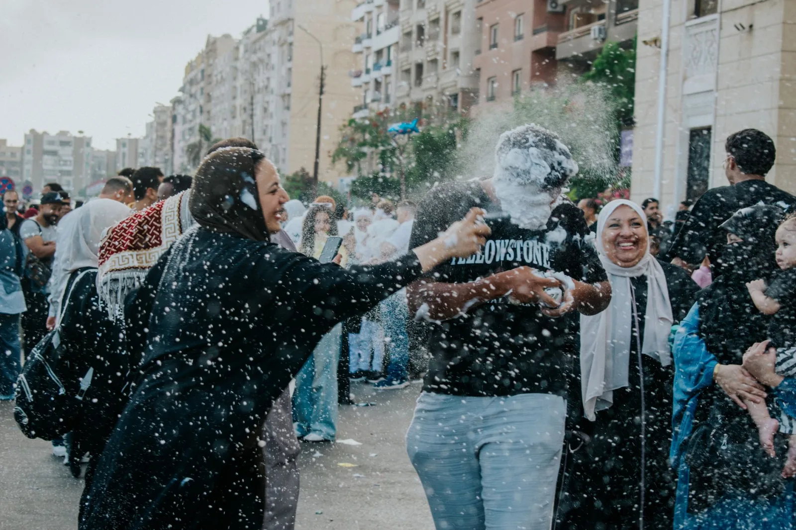 People enjoying a vibrant street festival celebration in Cairo, Egypt, with playful games and joyful interaction.