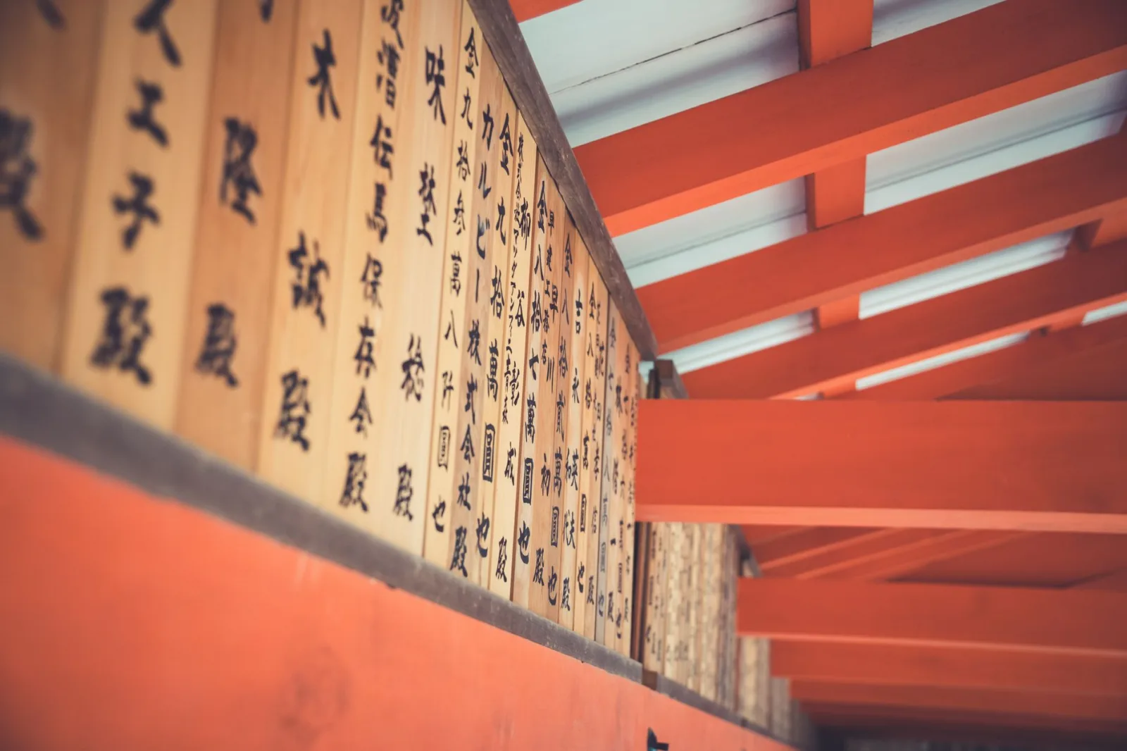 Japanese wooden beams with calligraphy in a traditional setting. Cultural and artistic heritage.