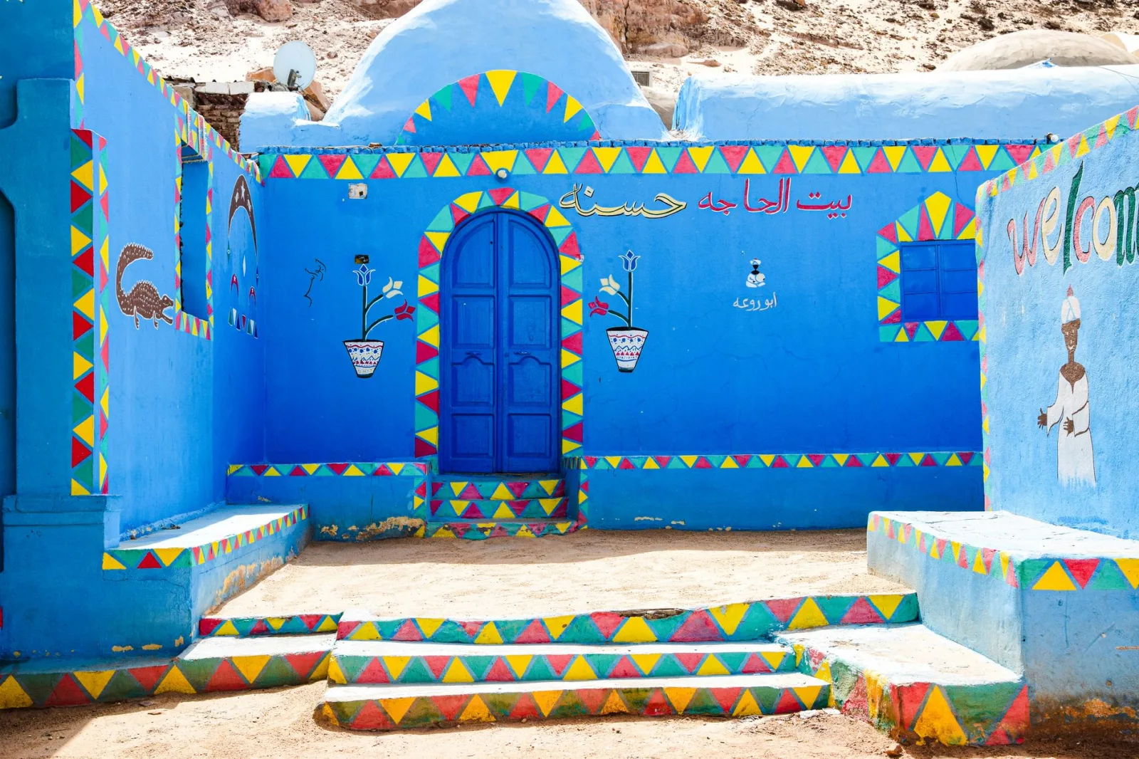 Vivid Nubian village scene showcasing colorful traditional architecture and artistic murals.