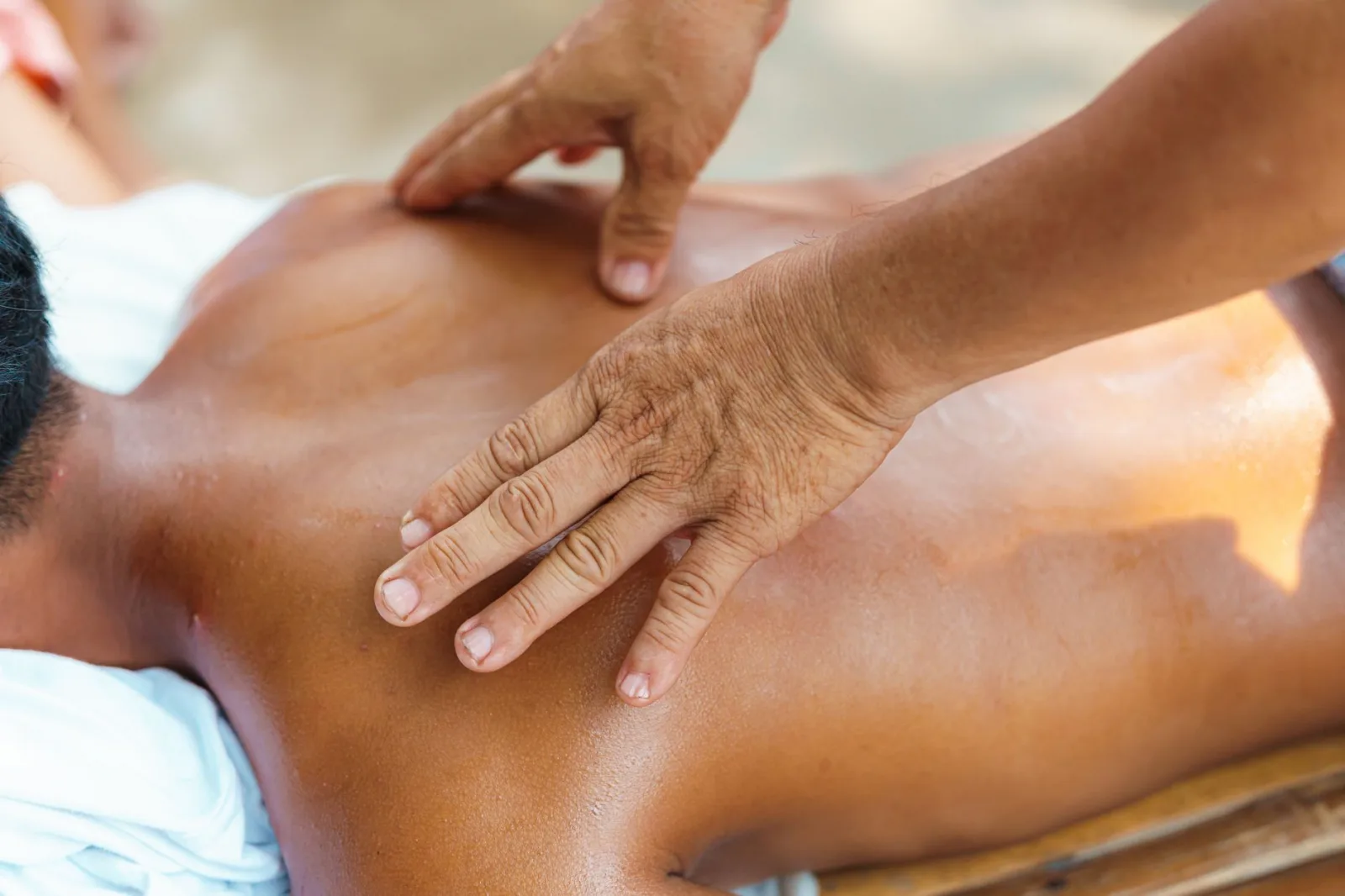 Close-up of a relaxing back massage in a tranquil spa environment, capturing the soothing touch of expert hands.