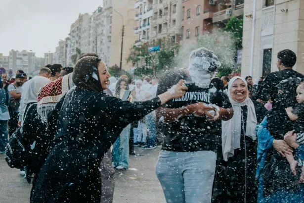 People enjoying a vibrant street festival celebration in Cairo, Egypt, with playful games and joyful interaction.