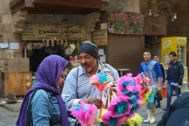 People interacting at a lively market in Cairo, displaying cultural diversity and vibrant street life.