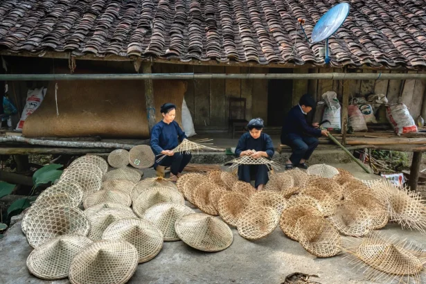 Artisans skillfully weave baskets in a rural village, showcasing traditional craftsmanship.