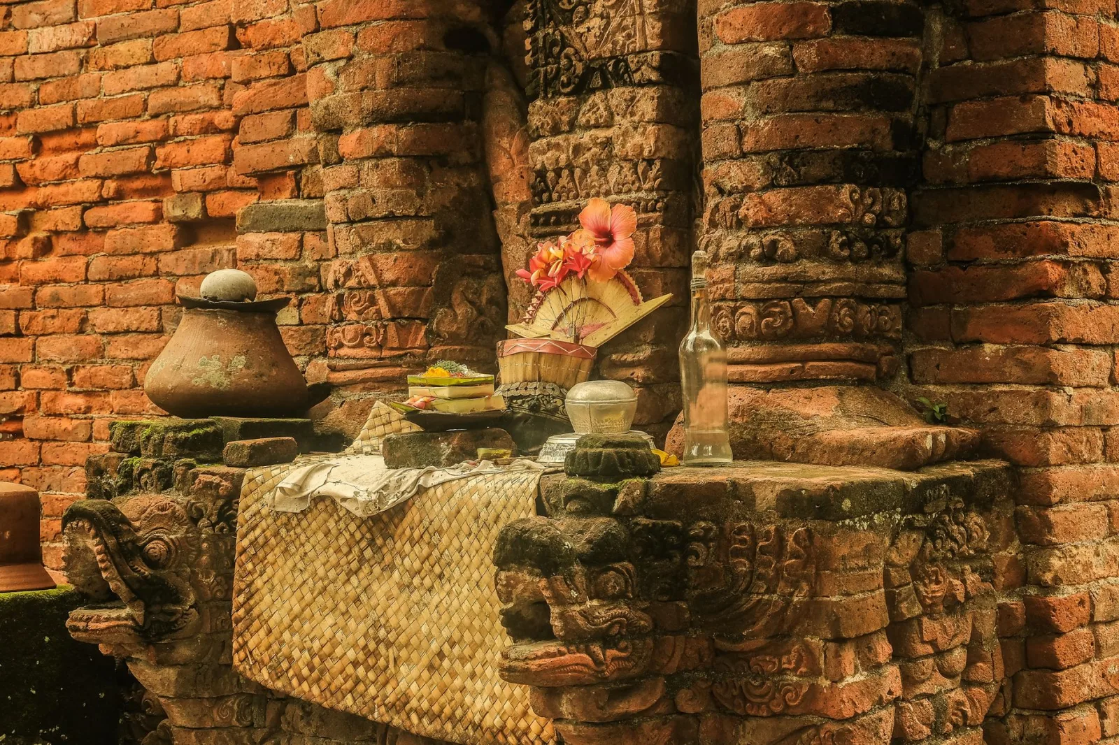 Atmospheric scene of a traditional offering at an ancient Balinese temple, showcasing rich cultural heritage.
