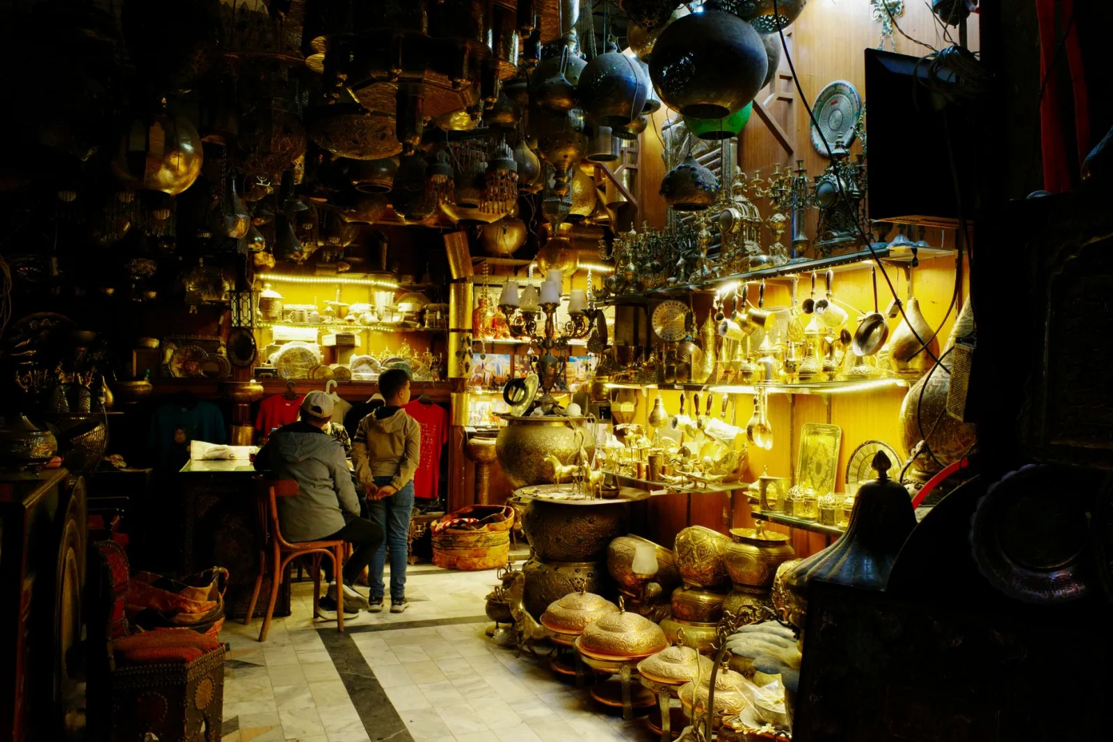 Explore a bustling Cairo souk filled with antique brassware and vibrant culture, perfect for exotic decor.