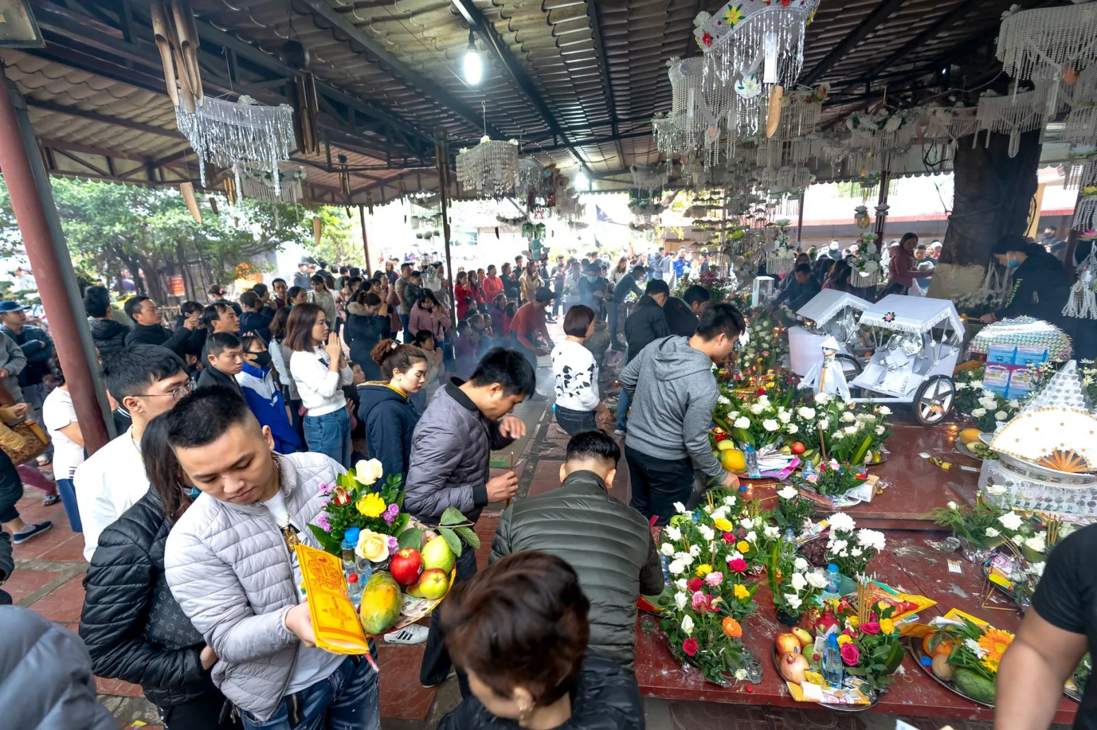 A bustling market scene with colorful flowers and fruit offerings, capturing cultural traditions.