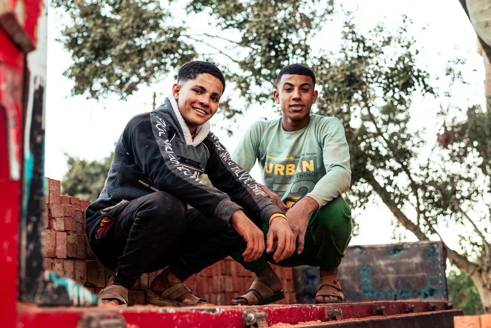 Two young men posing outdoors in Cairo, showcasing urban street style in a vibrant setting.