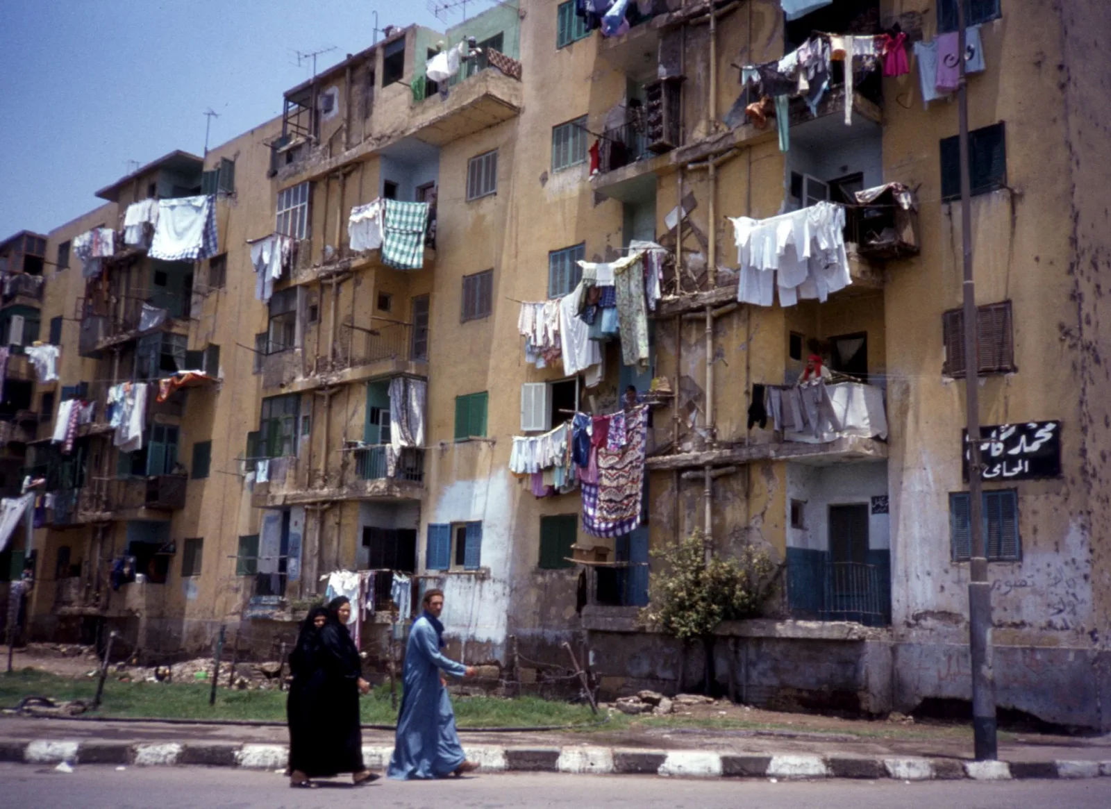 Urban scene with pedestrians and apartment buildings in Cairo, Egypt.
