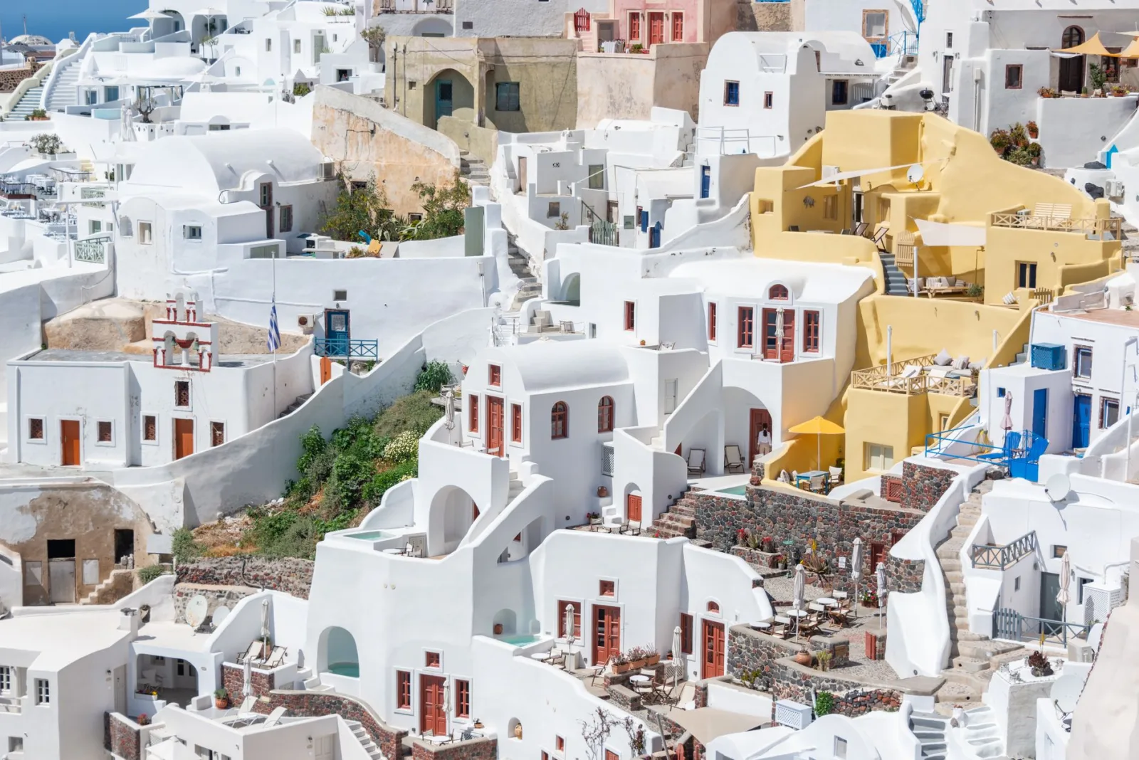 A stunning view of Santorini's classic white and blue architectural landscape in summer.