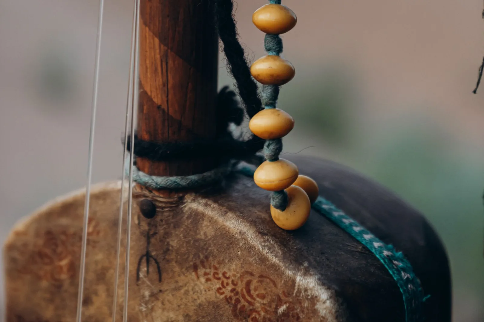 Detailed view of a traditional string instrument from Morocco with beads.