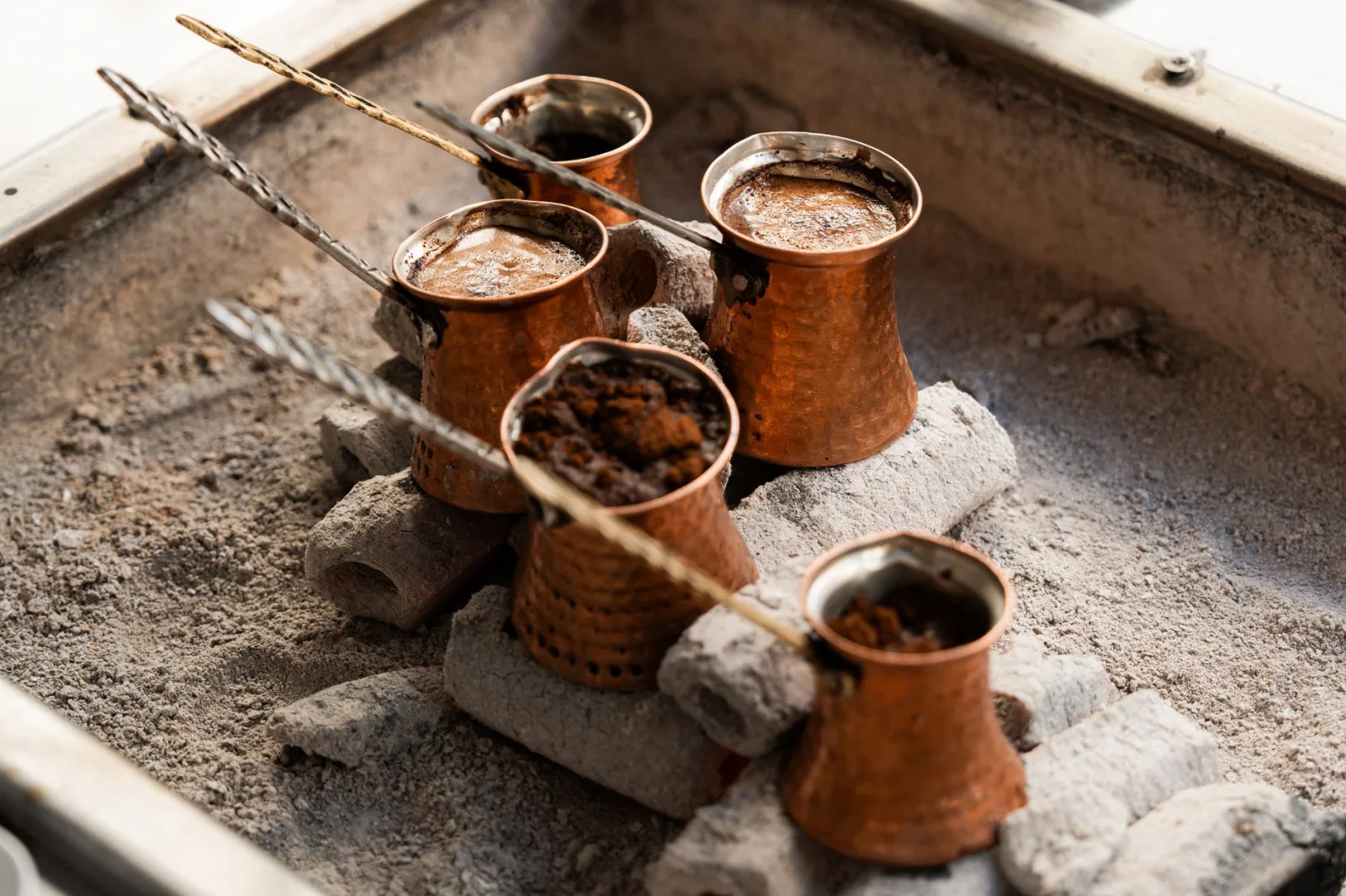 Copper cezves used for brewing traditional Turkish coffee over hot sand.