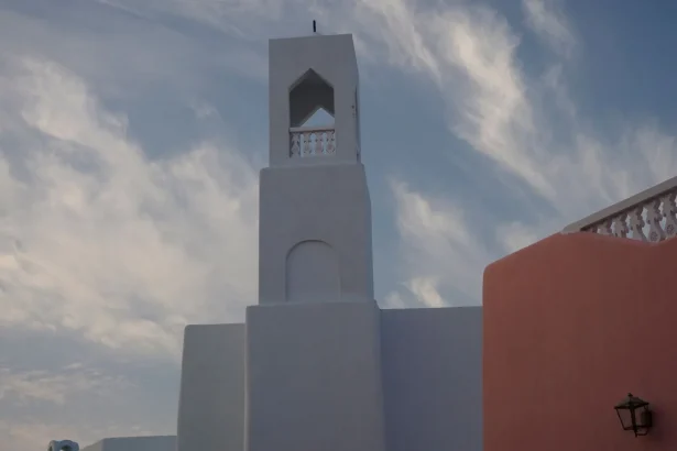 A striking modern building in Doha, Qatar against a dramatic blue sky.