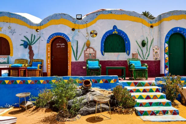 Vibrant Nubian house facade with colorful walls and traditional decor in Egypt's rural area.