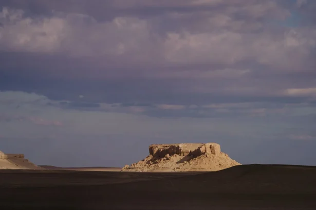 Explore the captivating rock formations of Faiyum, Egypt at sunset, showcasing natural desert beauty.
