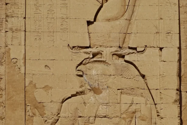Intricate relief depicting Egyptian deity, showcasing ancient art in Edfu Temple, Aswan.