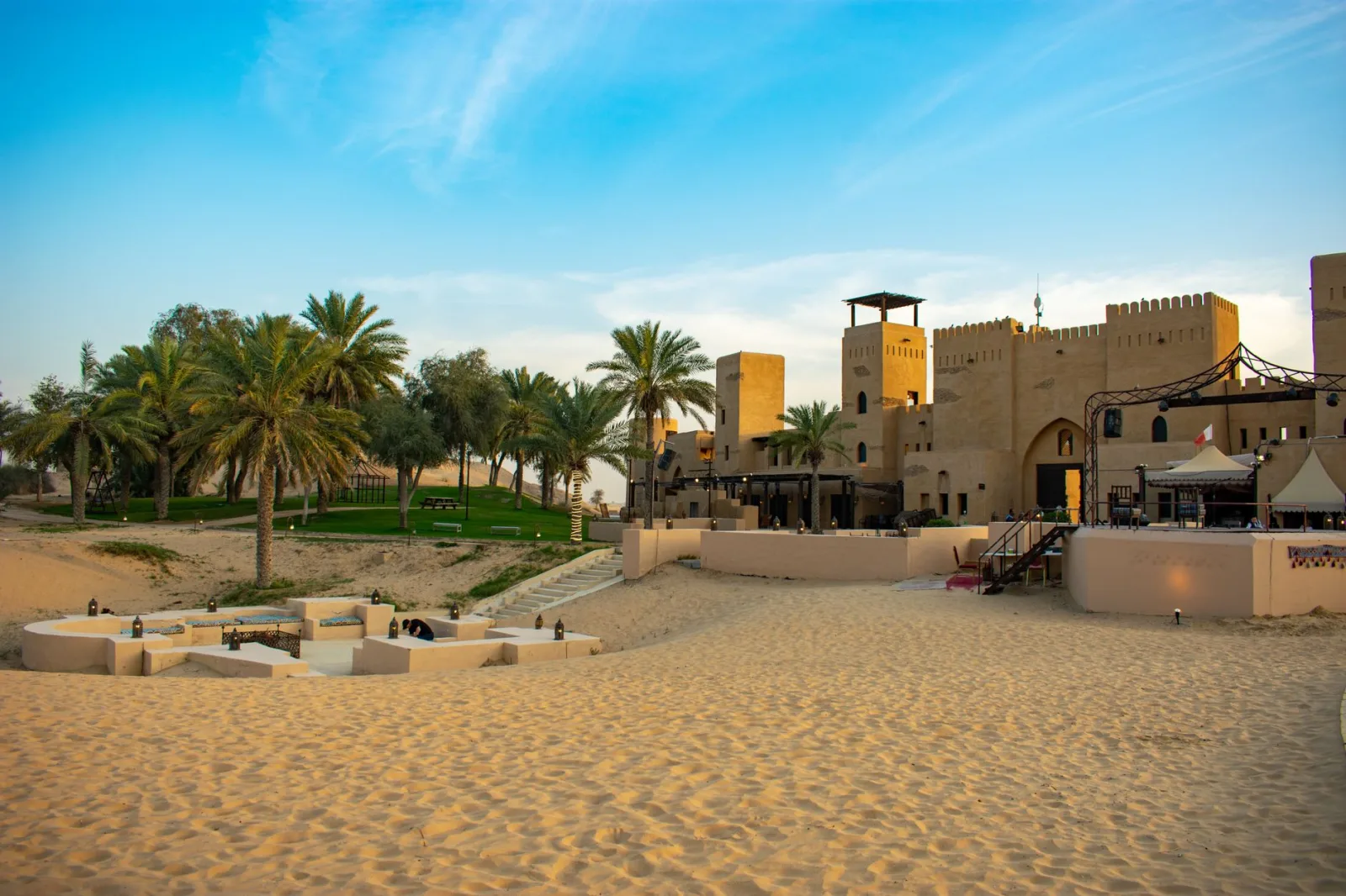 A stunning desert resort surrounded by palm trees at sunset, perfect for a tropical getaway.