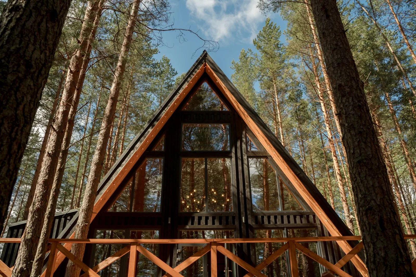 Stunning A-frame cabin surrounded by tall trees in a serene forest. Perfect for nature escapes.