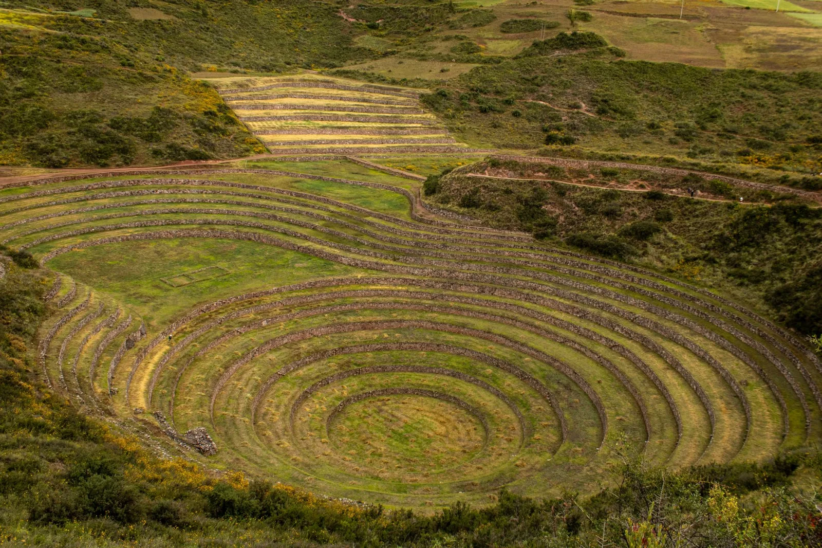 Explore the ancient Incan agricultural terraces of Moray in Cusco, Peru, from above.